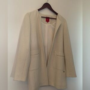 Cream dress jacket with wrist-length sleeves.